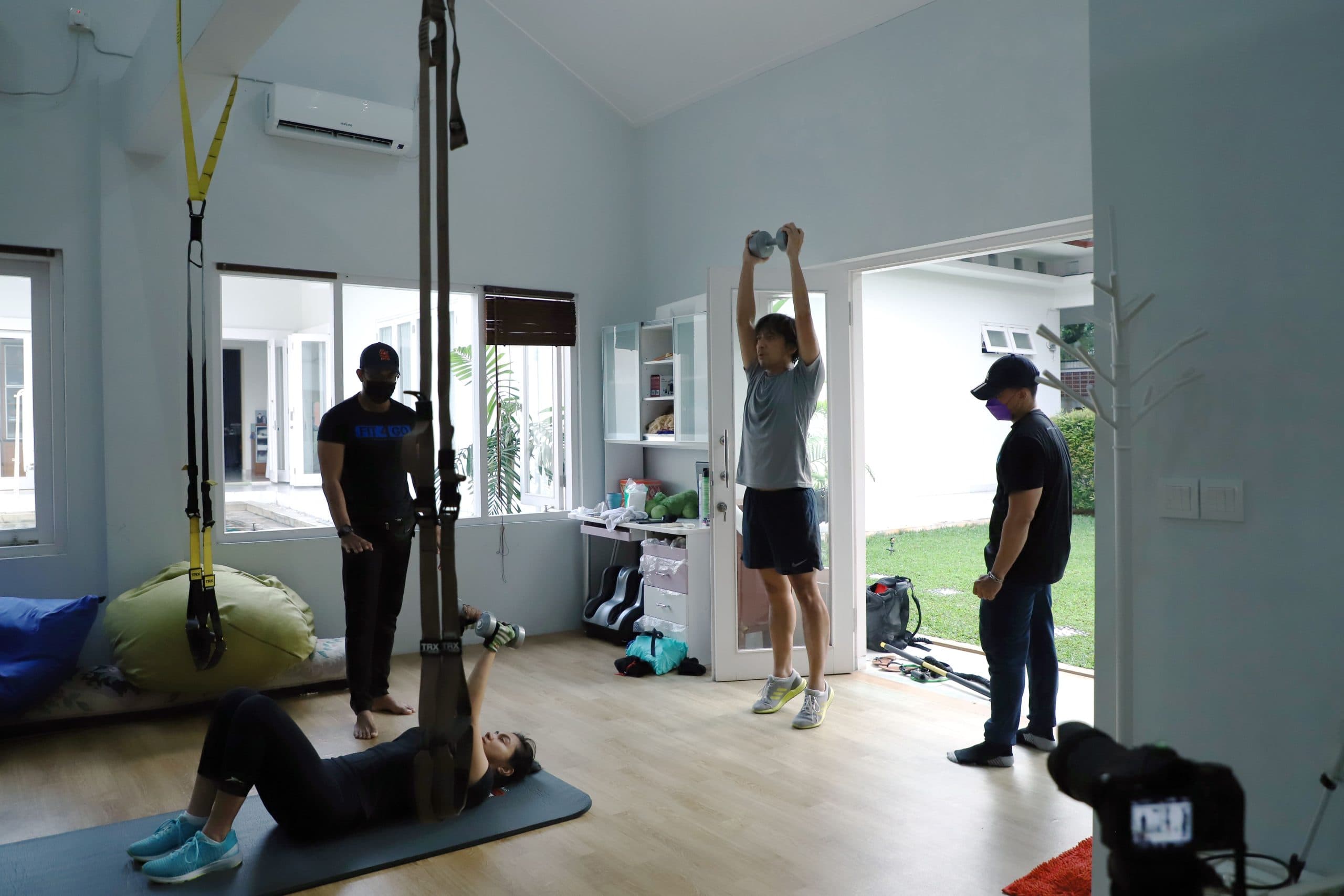 A Fit4Go trainer guiding a personal training session